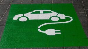 Green electric car symbol on the ground